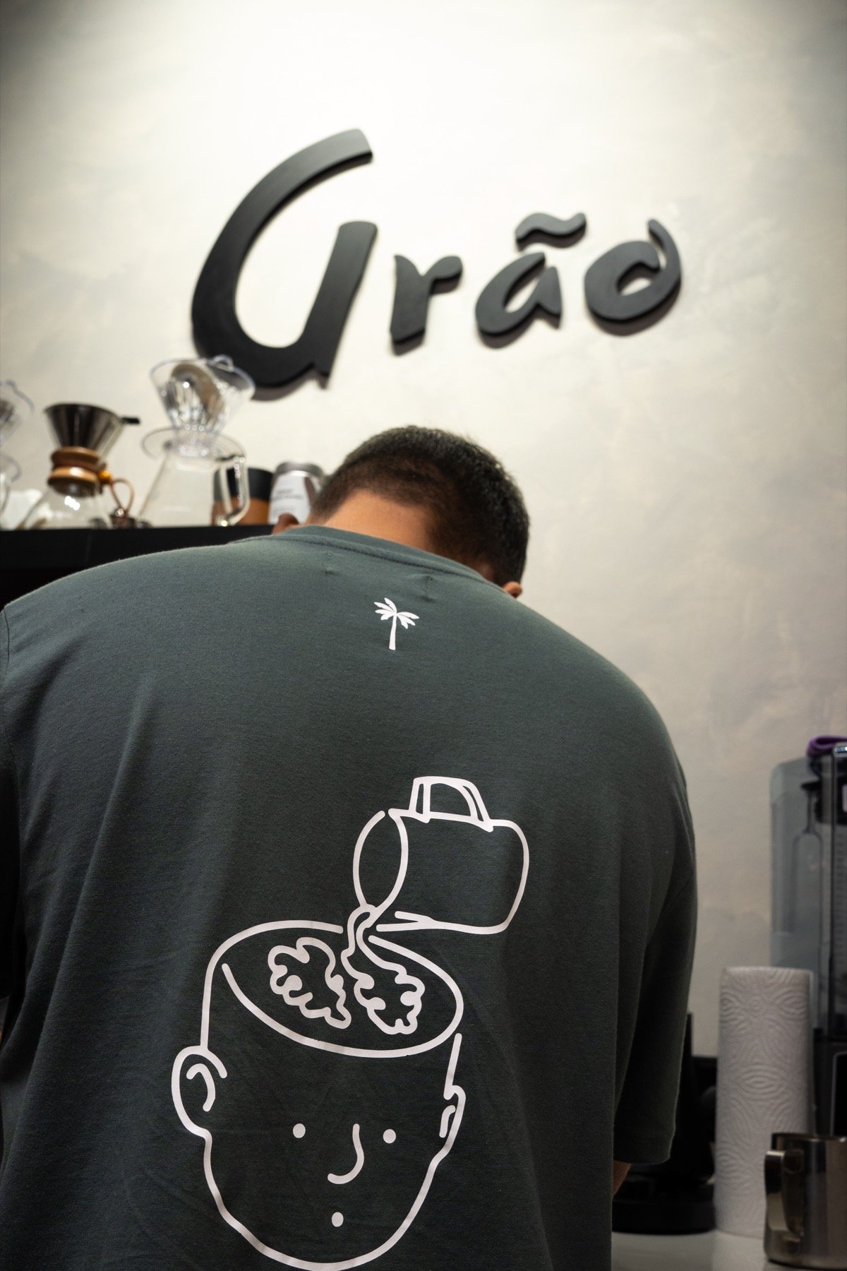 Barista hand-pouring filter coffee at Grāo